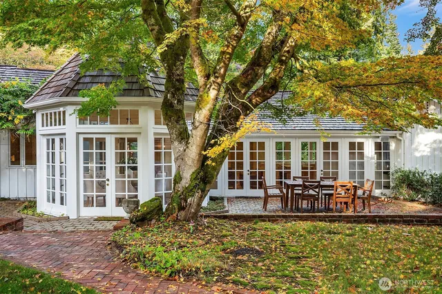 front view of a house with a large window and table