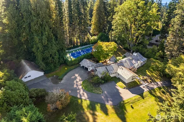 an aerial view of a house with yard swimming pool and outdoor seating