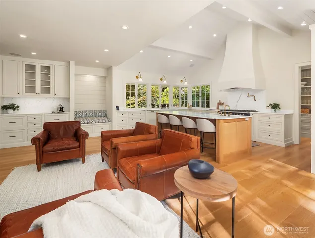 a living room with furniture and a kitchen view