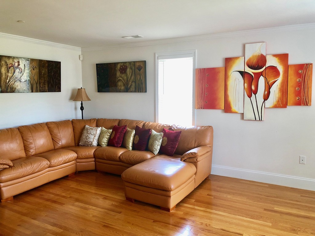 a living room with furniture and a painting