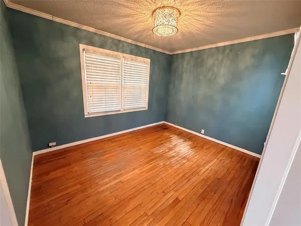 wooden floor in a room next to a window