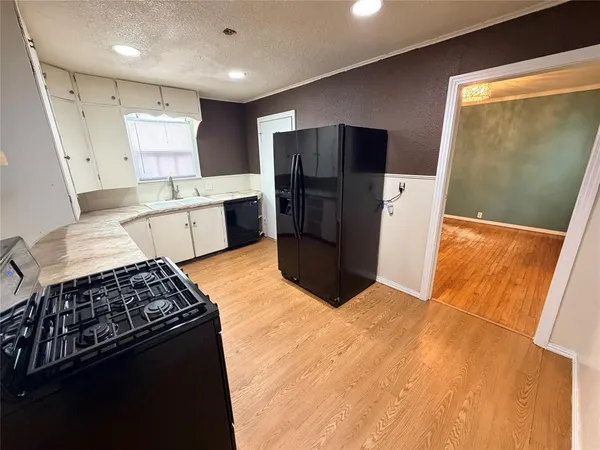 a kitchen with stainless steel appliances a refrigerator a sink a stove a microwave a counter top and oven