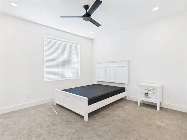 a living room with a bed and a window