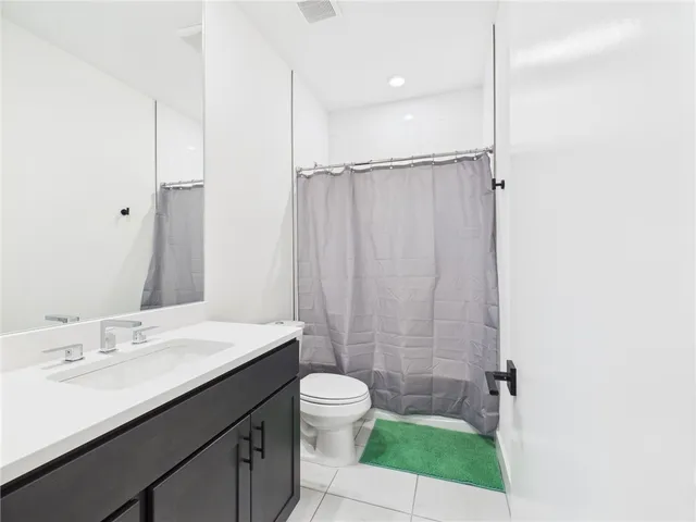 a bathroom with a sink a toilet a shower and a mirror