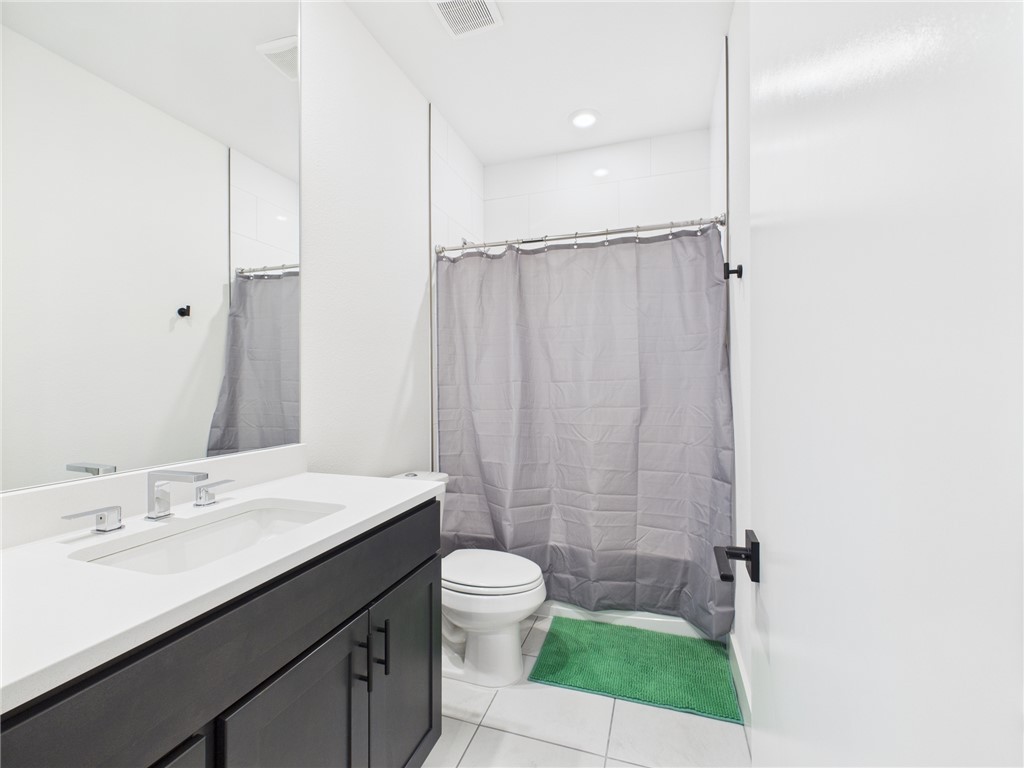2940 Huffman Way College Station, TX 77840 - Photo 16 of 29 a bathroom with a sink a toilet a shower and a mirror