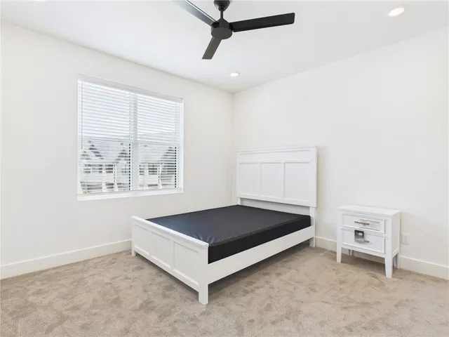 a living room with a bed and a window