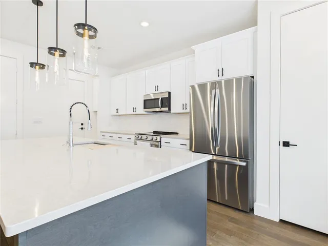 a kitchen with refrigerator and cabinets