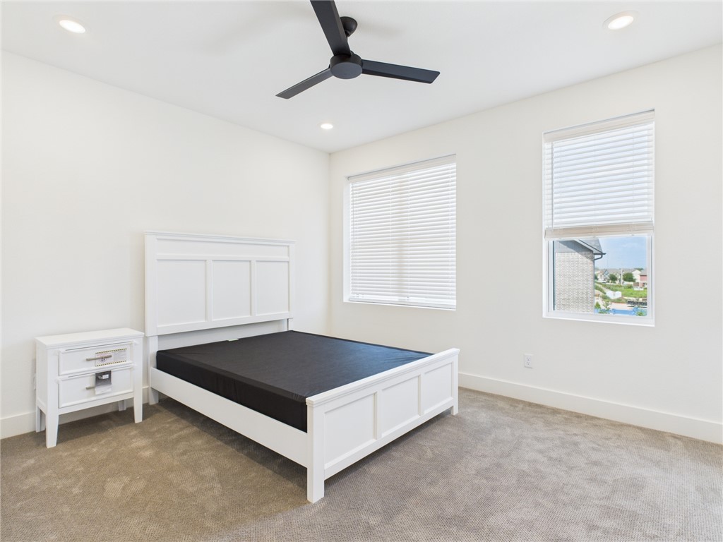2940 Huffman Way College Station, TX 77840 - Photo 23 of 29 a spacious bedroom with a bed and a window