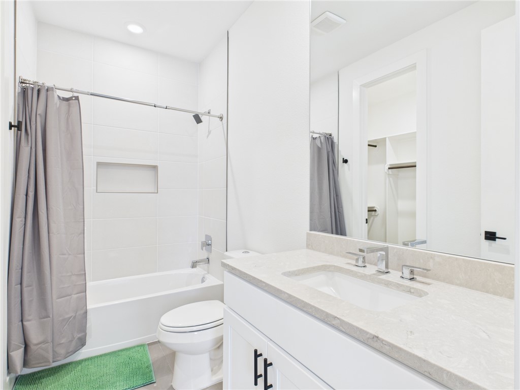 2940 Huffman Way College Station, TX 77840 - Photo 24 of 29 a bathroom with a granite countertop sink toilet and shower
