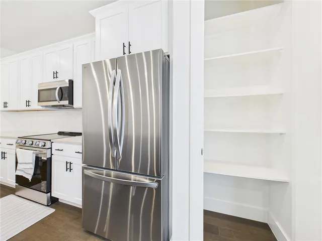 a kitchen with cabinets and stainless steel appliances