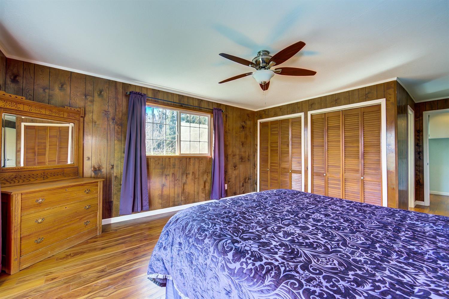 4149 Hilsinger Road Phoenix, OR 97535 - Photo 16 of 35 a bedroom with a large bed and large window