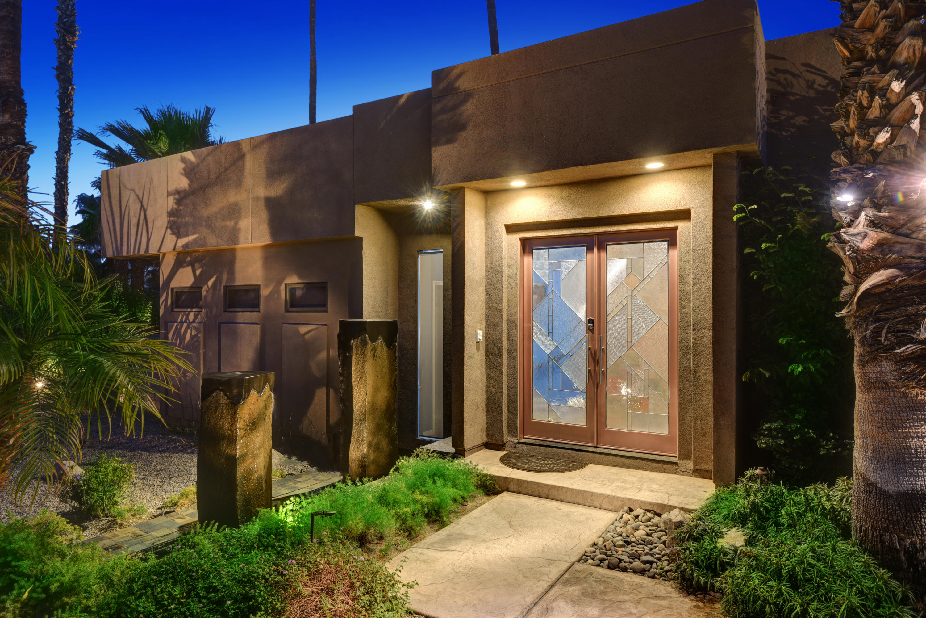 73543 Juniper Street Palm Desert, CA 92260 - Photo 18 of 44 a front view of a house with a garden
