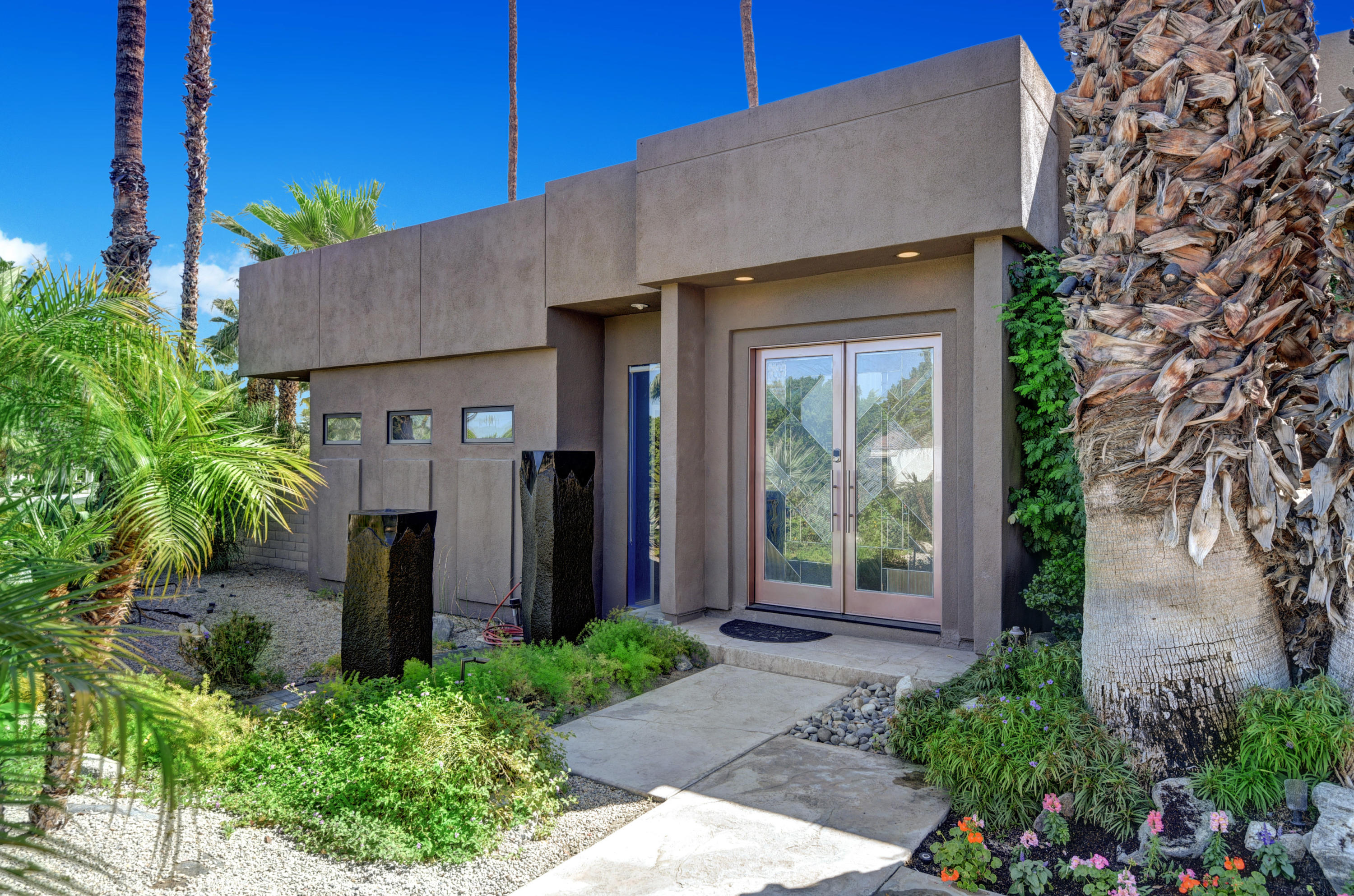 73543 Juniper Street Palm Desert, CA 92260 - Photo 19 of 44 a front view of a house with garden