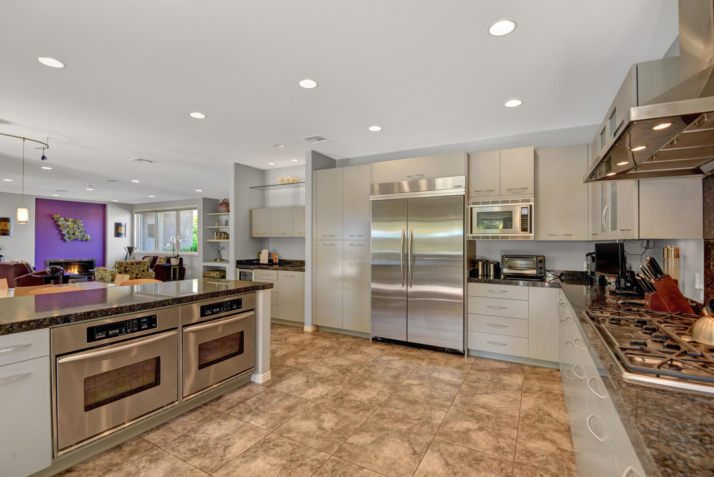 73543 Juniper Street Palm Desert, CA 92260 - Photo 25 of 44 a kitchen with stainless steel appliances a stove a sink and a refrigerator
