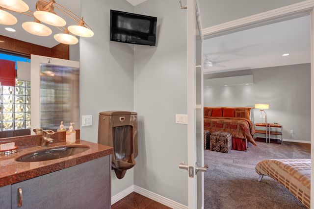 a view of a livingroom with workspace and a window