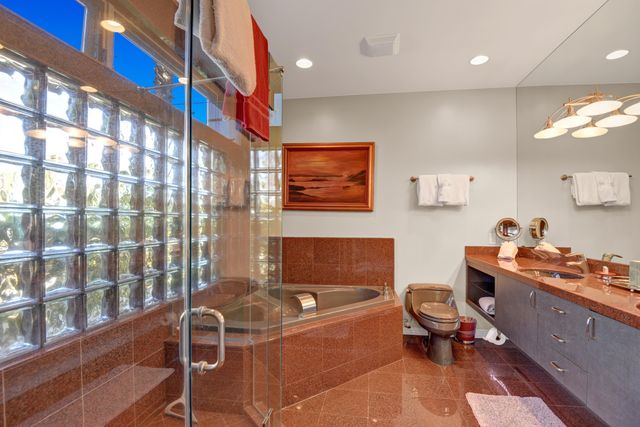 a living room with furniture and a painting on the wall