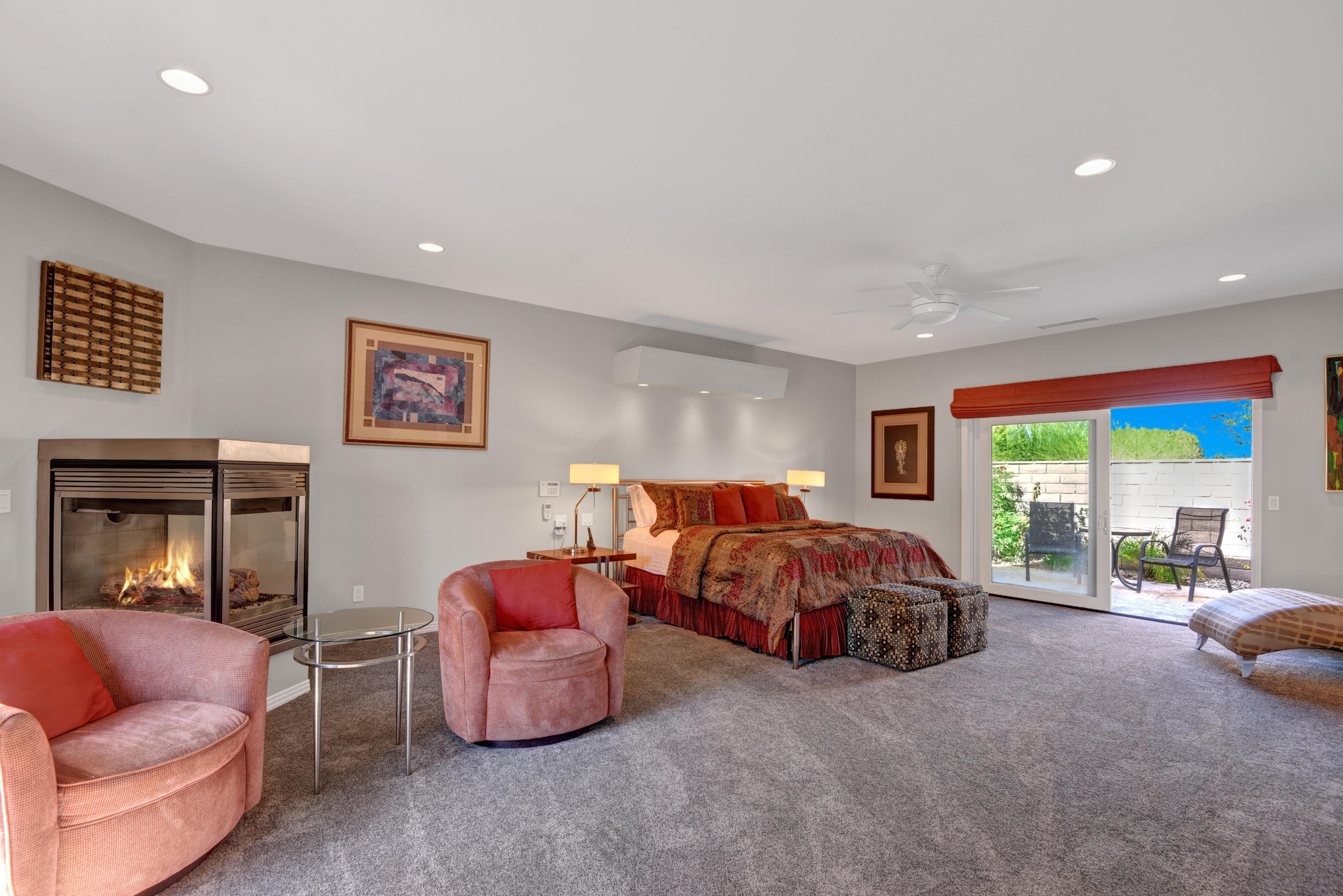 73543 Juniper Street Palm Desert, CA 92260 - Photo 32 of 44 a spacious bedroom with a bed and glass couch