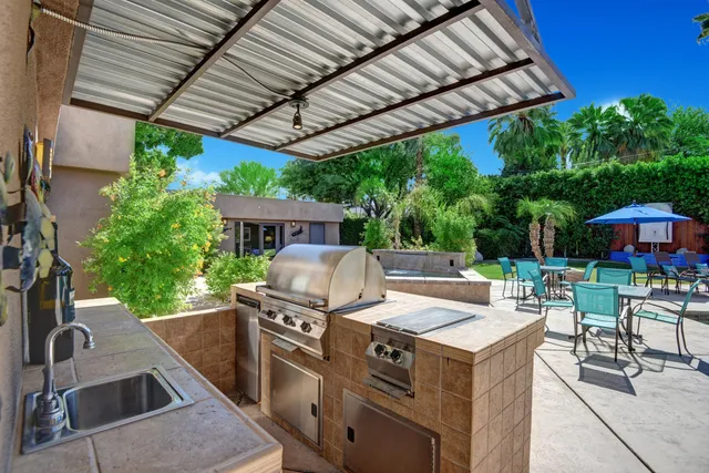 a view of a patio with table and chairs potted plants with wooden floor