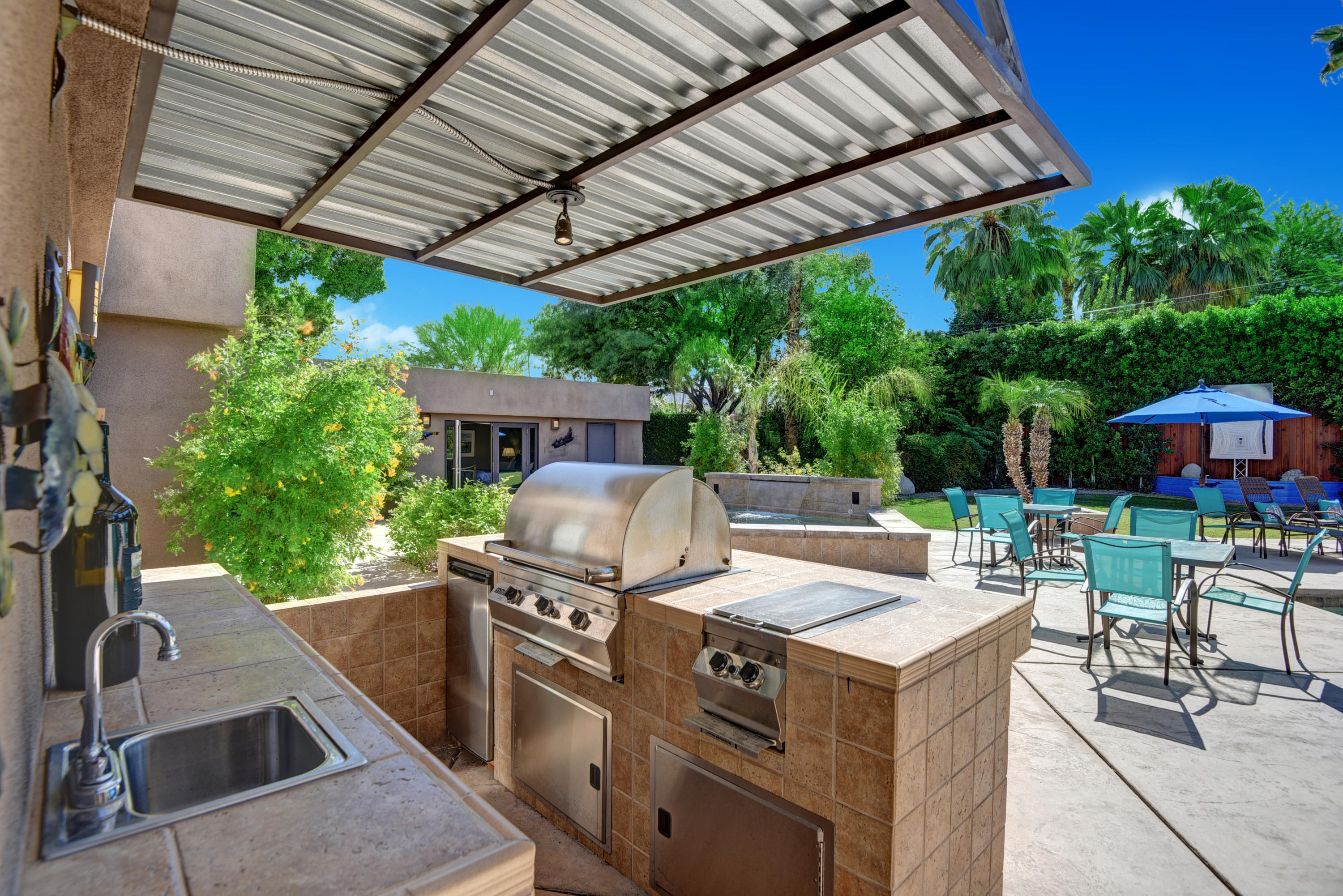 73543 Juniper Street Palm Desert, CA 92260 - Photo 34 of 44 a view of a patio with table and chairs potted plants with wooden floor