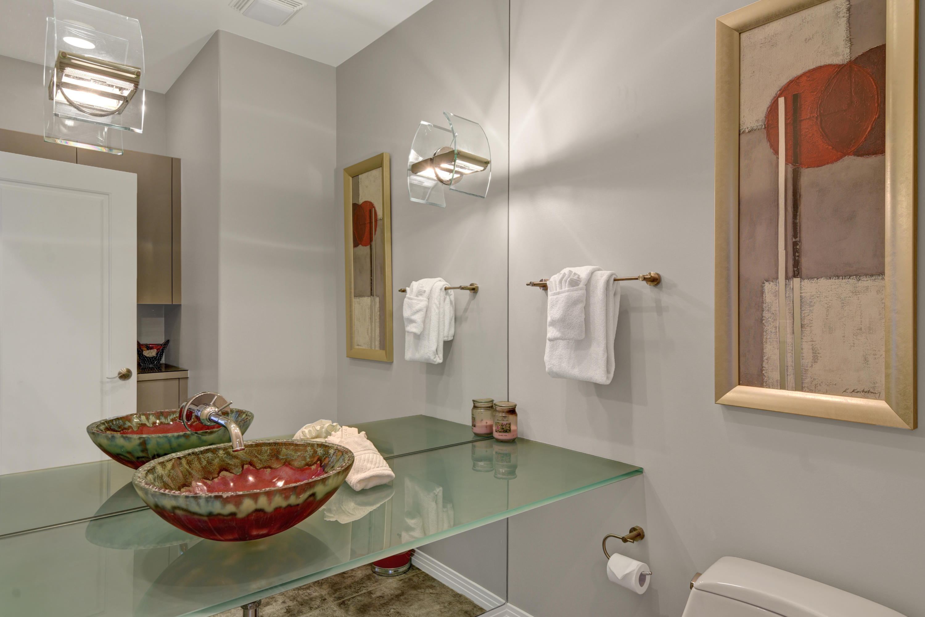 73543 Juniper Street Palm Desert, CA 92260 - Photo 39 of 44 a bathroom with a granite countertop sink a toilet and a mirror