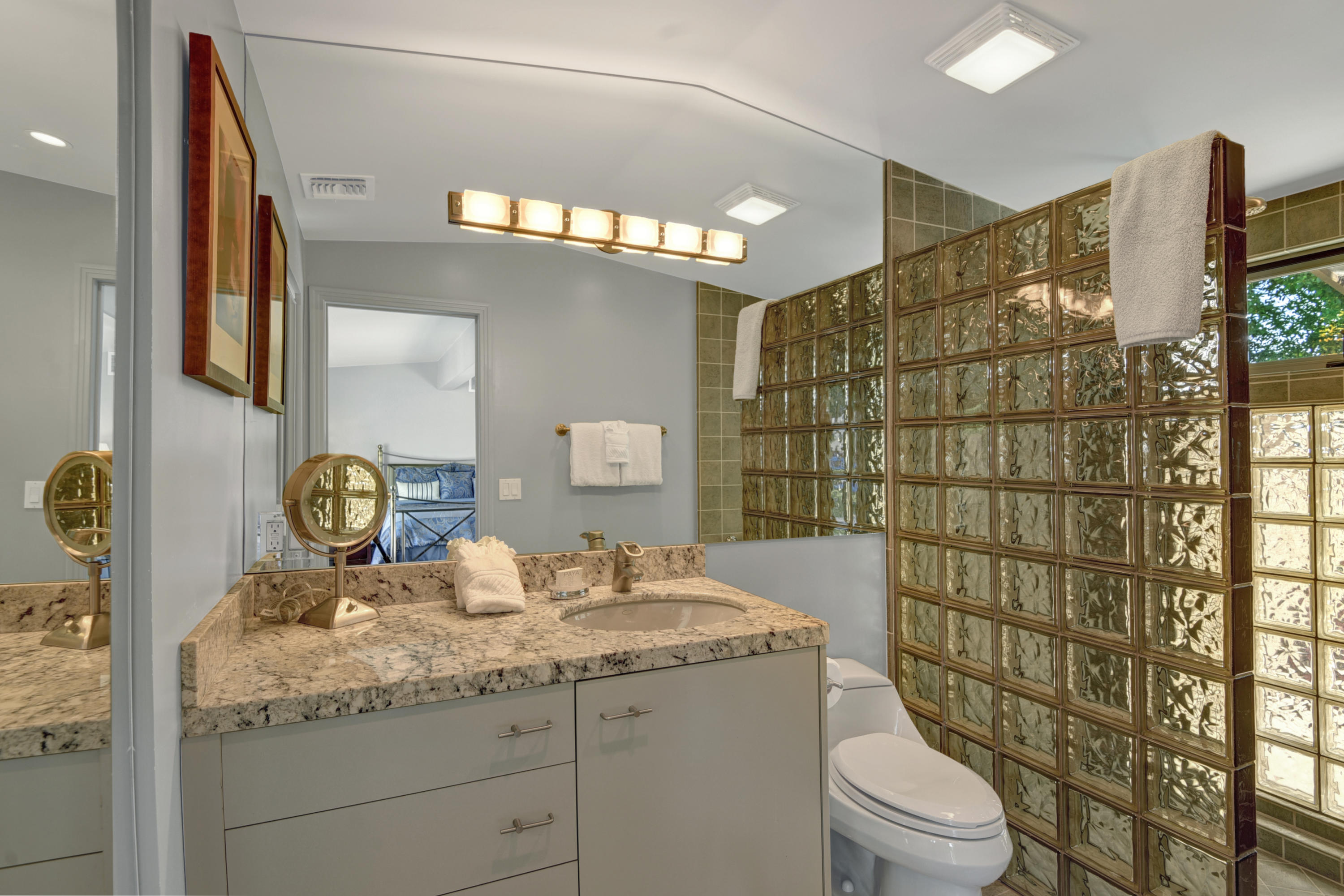 73543 Juniper Street Palm Desert, CA 92260 - Photo 4 of 44 a bathroom with a granite countertop sink a toilet and shower