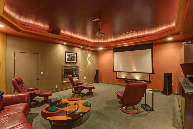 a room with furniture a projector and screen