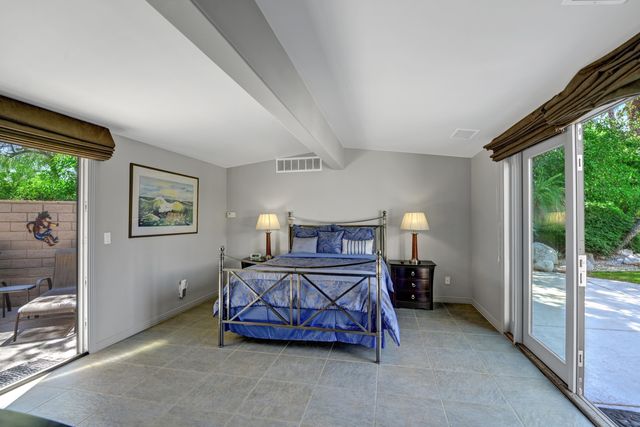 a bedroom with a bed and a balcony