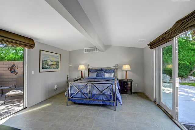 a bedroom with a bed and a balcony