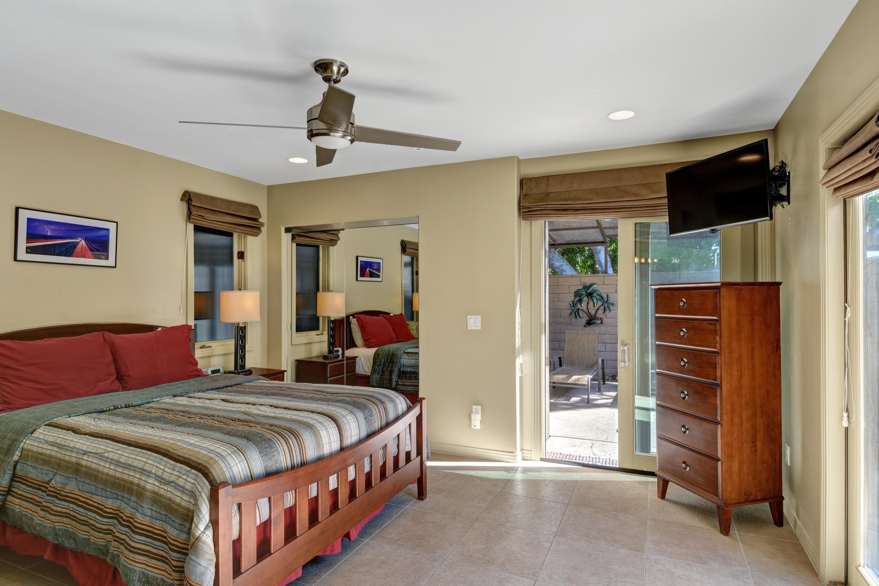 73543 Juniper Street Palm Desert, CA 92260 - Photo 7 of 44 a bedroom with a bed and a chandelier