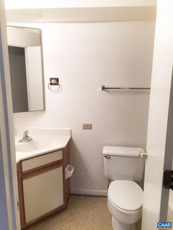 a bathroom with a toilet a sink and a mirror