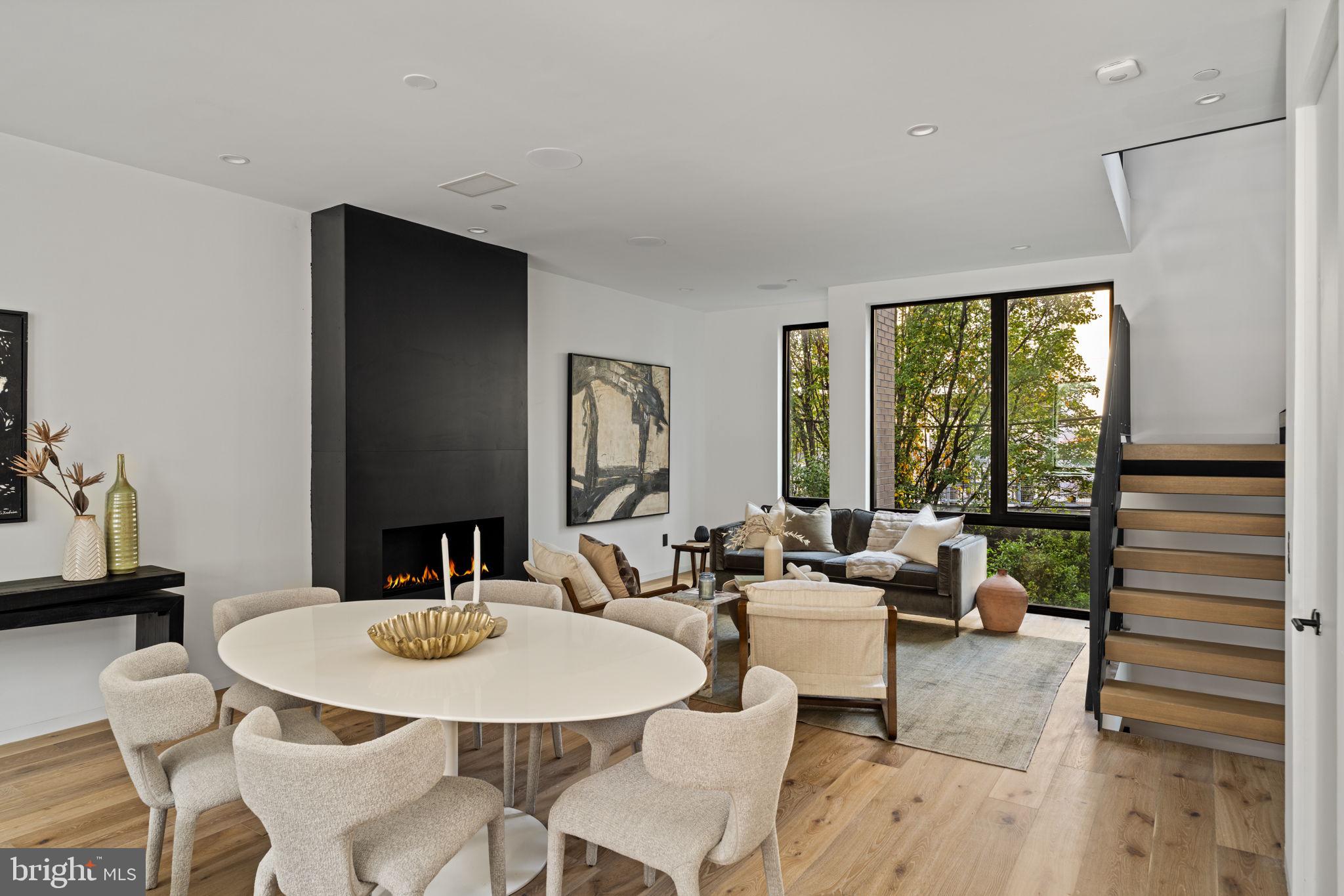 a view of a dining room with furniture large windows and wooden floor