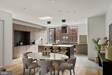 a living room with furniture and a dining table