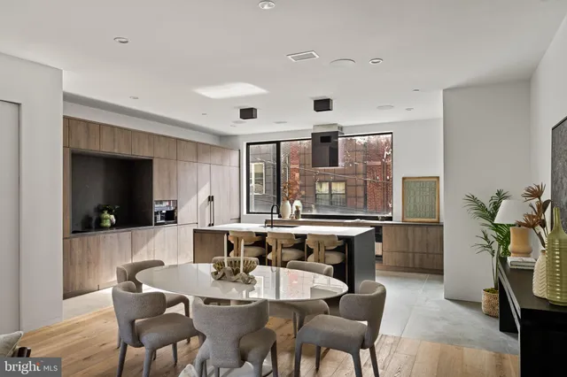 a living room with furniture and a dining table