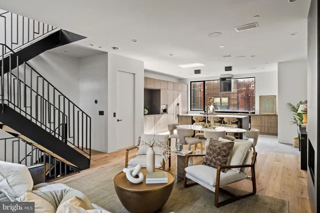 a kitchen with a table chairs sink and cabinets