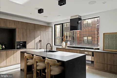 a kitchen with kitchen island a sink appliances and cabinets