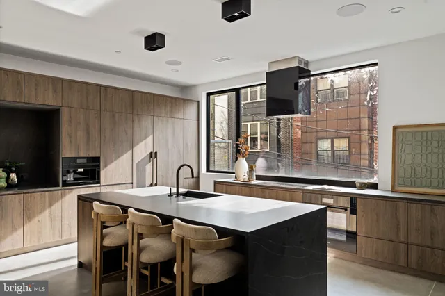a kitchen with kitchen island a sink appliances and cabinets