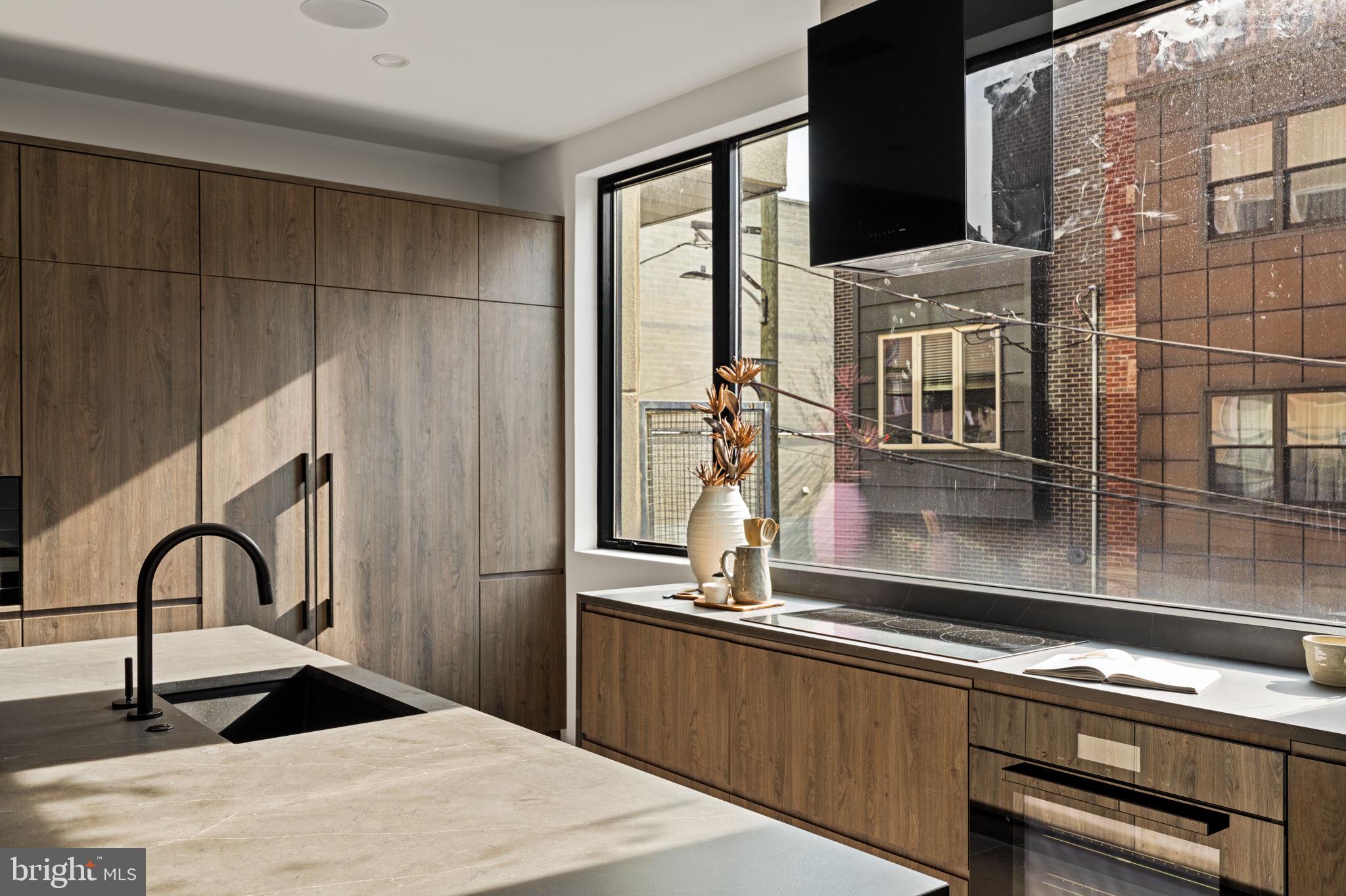 1428 Kenilworth Street Philadelphia, PA 19146 - Photo 19 of 58 a kitchen with kitchen island a sink appliances and cabinets
