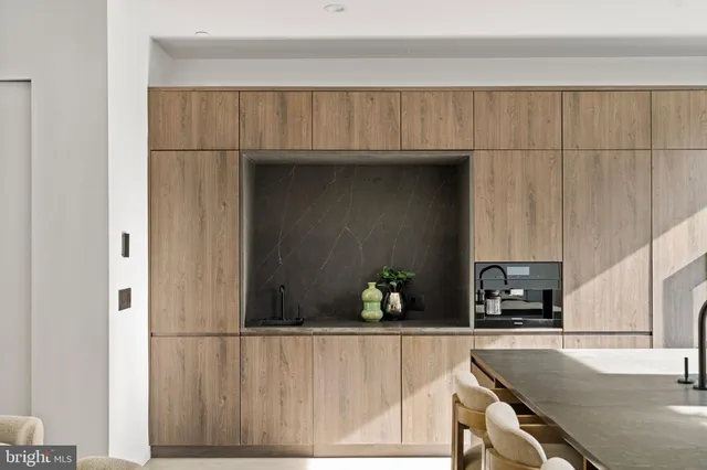 a kitchen with counter top space and living room view