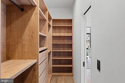 a bedroom with two beds and large window