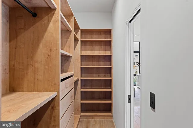 a bedroom with two beds and large window