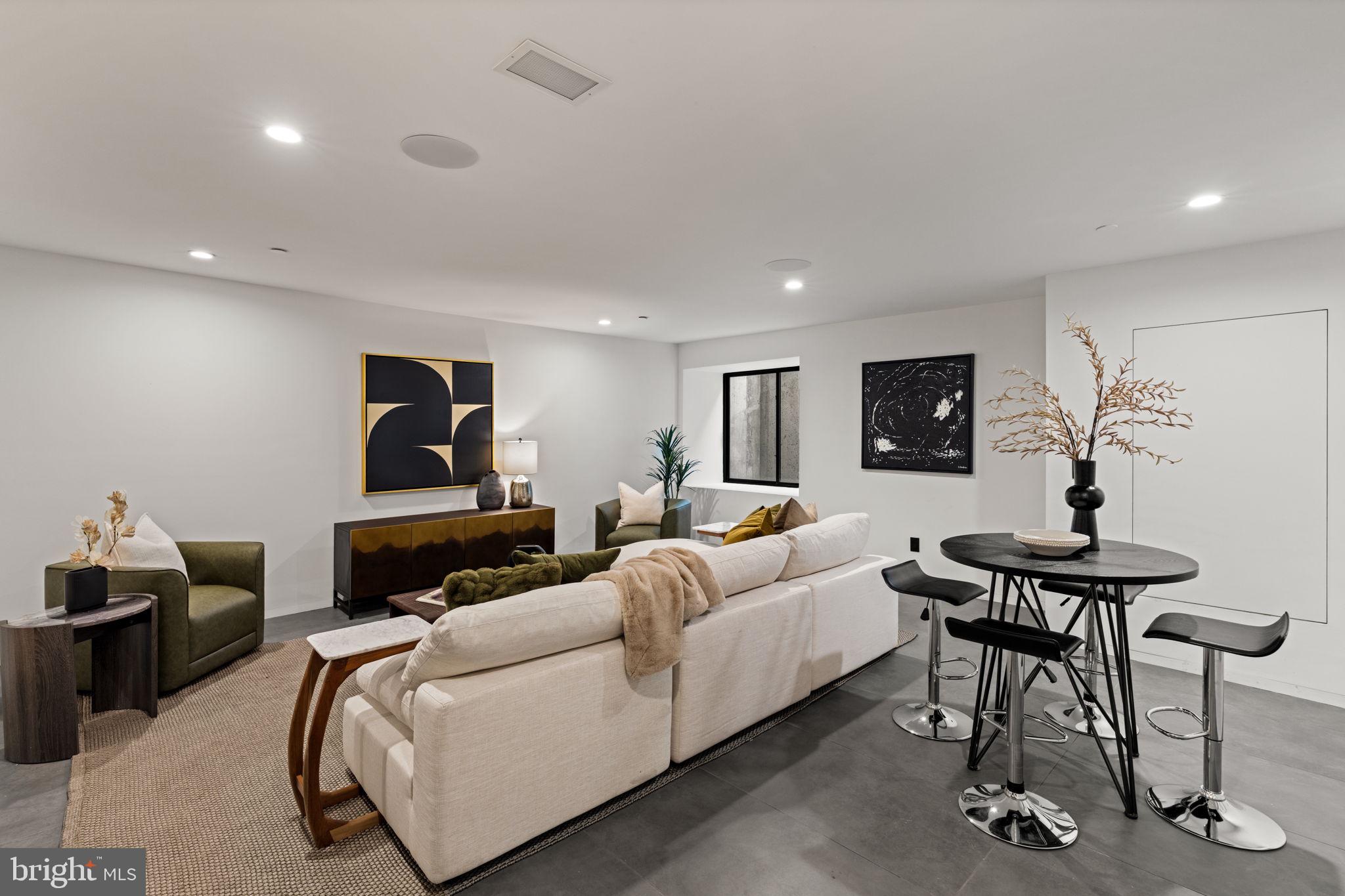 1428 Kenilworth Street Philadelphia, PA 19146 - Photo 49 of 58 a living room with furniture a clock and a flat screen tv