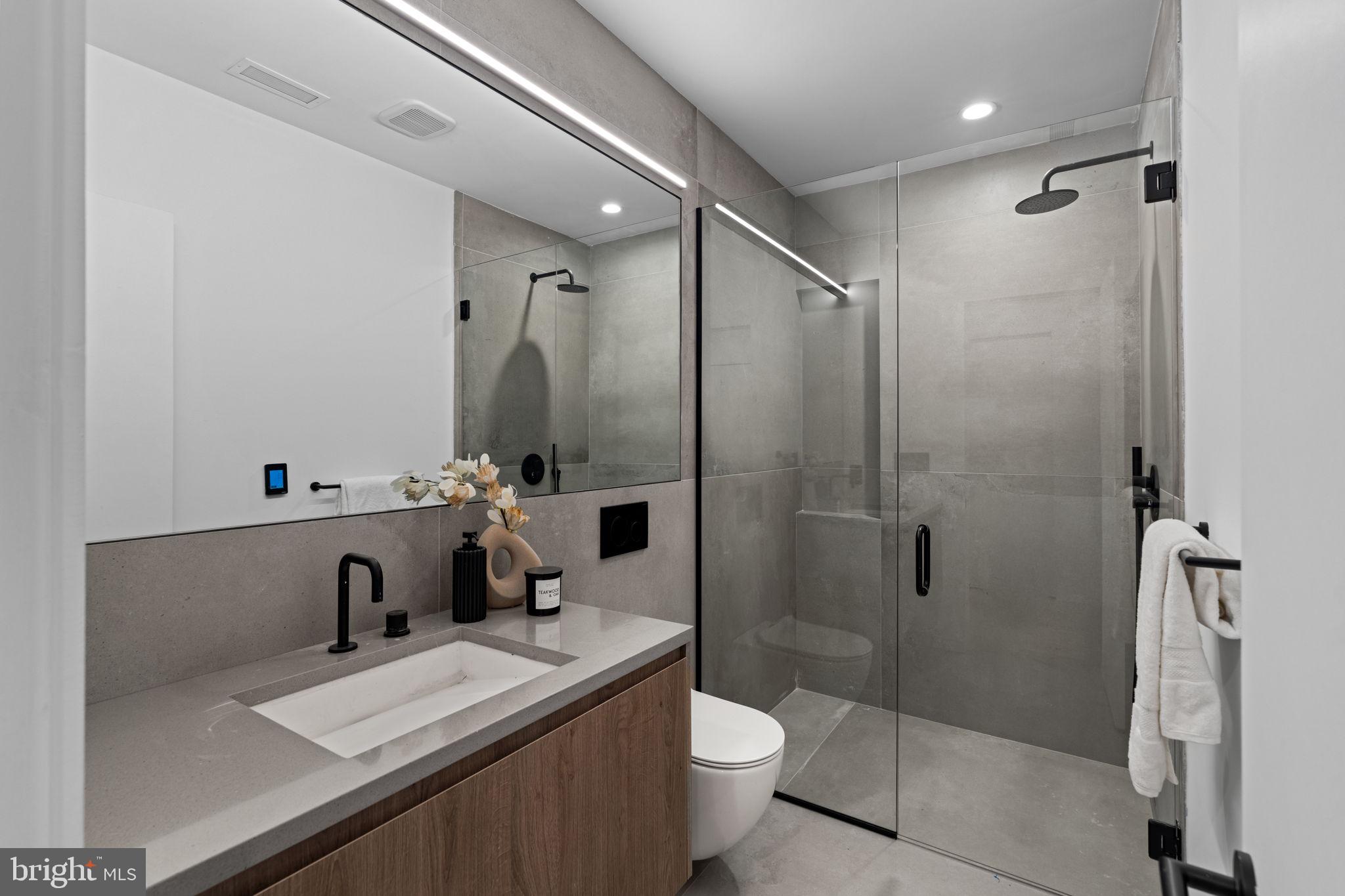 1428 Kenilworth Street Philadelphia, PA 19146 - Photo 52 of 58 a bathroom with a sink a toilet and shower