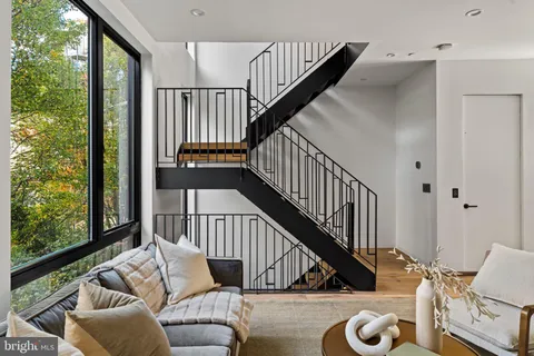 a living room with furniture and a floor to ceiling window