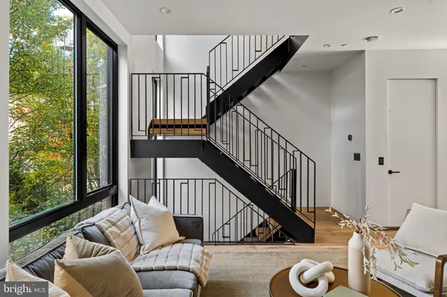a living room with furniture and a floor to ceiling window