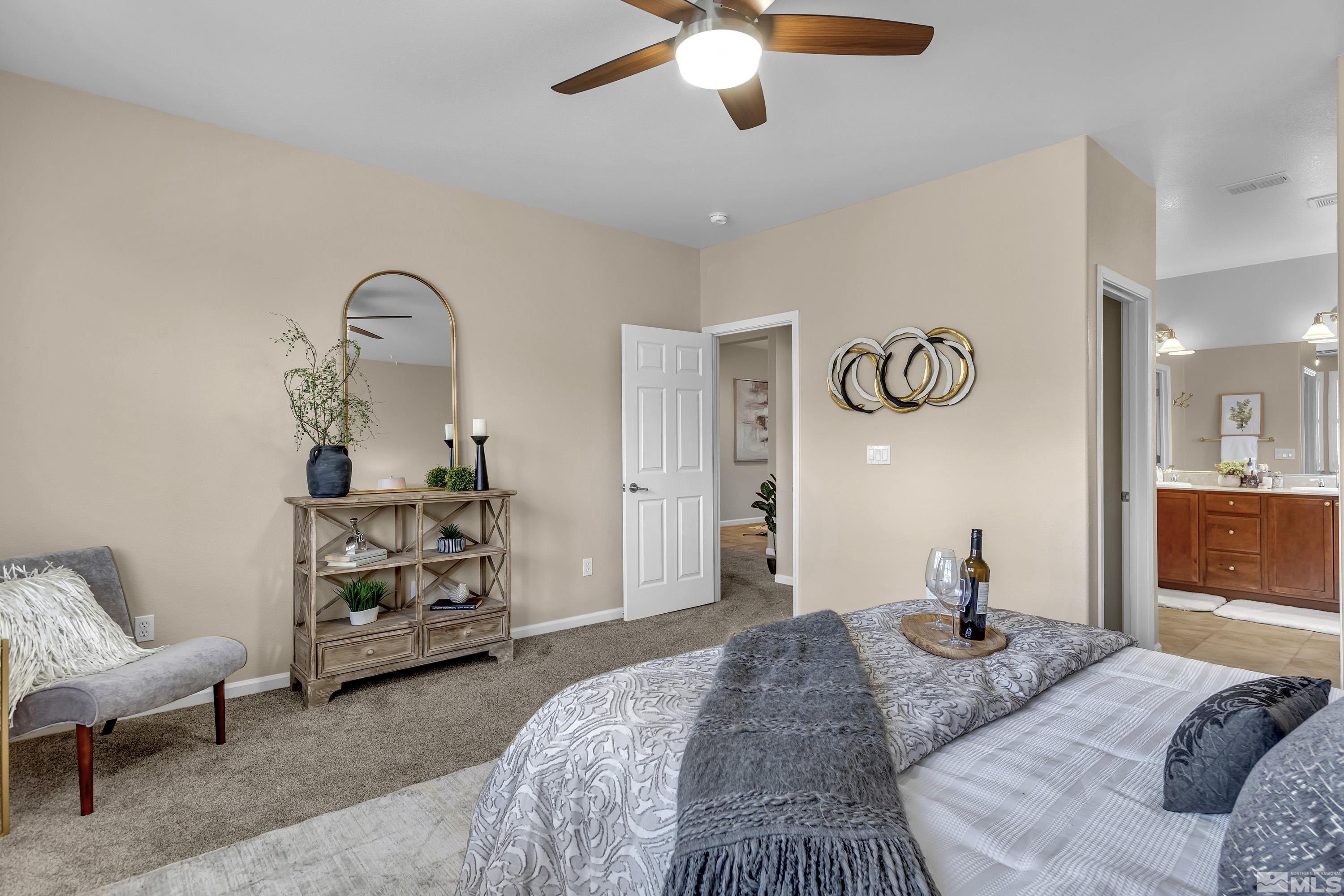 10797 Amber Falls Drive Reno, NV 89521 - Photo 12 of 38 a bedroom with furniture and a chandelier