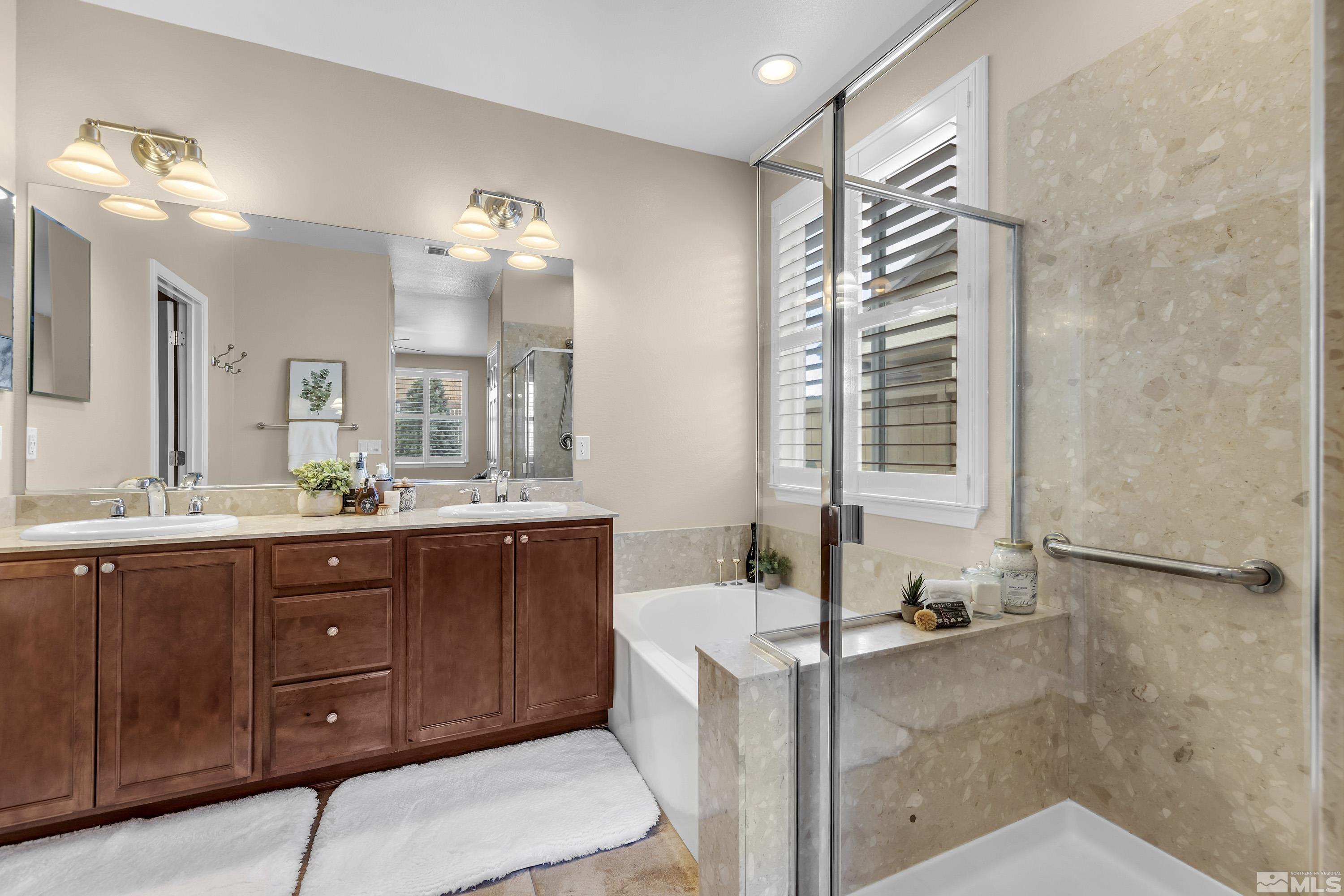 10797 Amber Falls Drive Reno, NV 89521 - Photo 13 of 38 a spacious bathroom with a granite countertop sink and a mirror