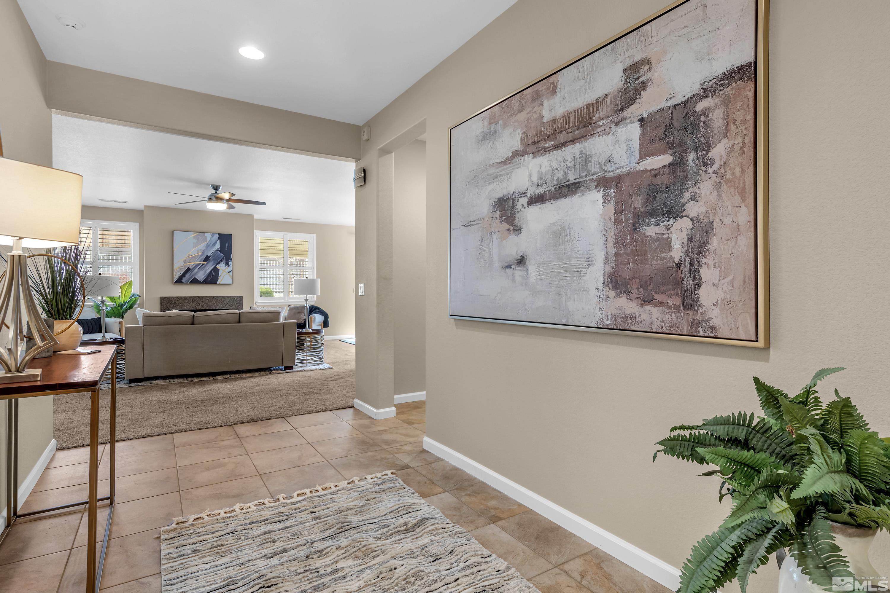 10797 Amber Falls Drive Reno, NV 89521 - Photo 16 of 38 a living room with furniture and a potted plant