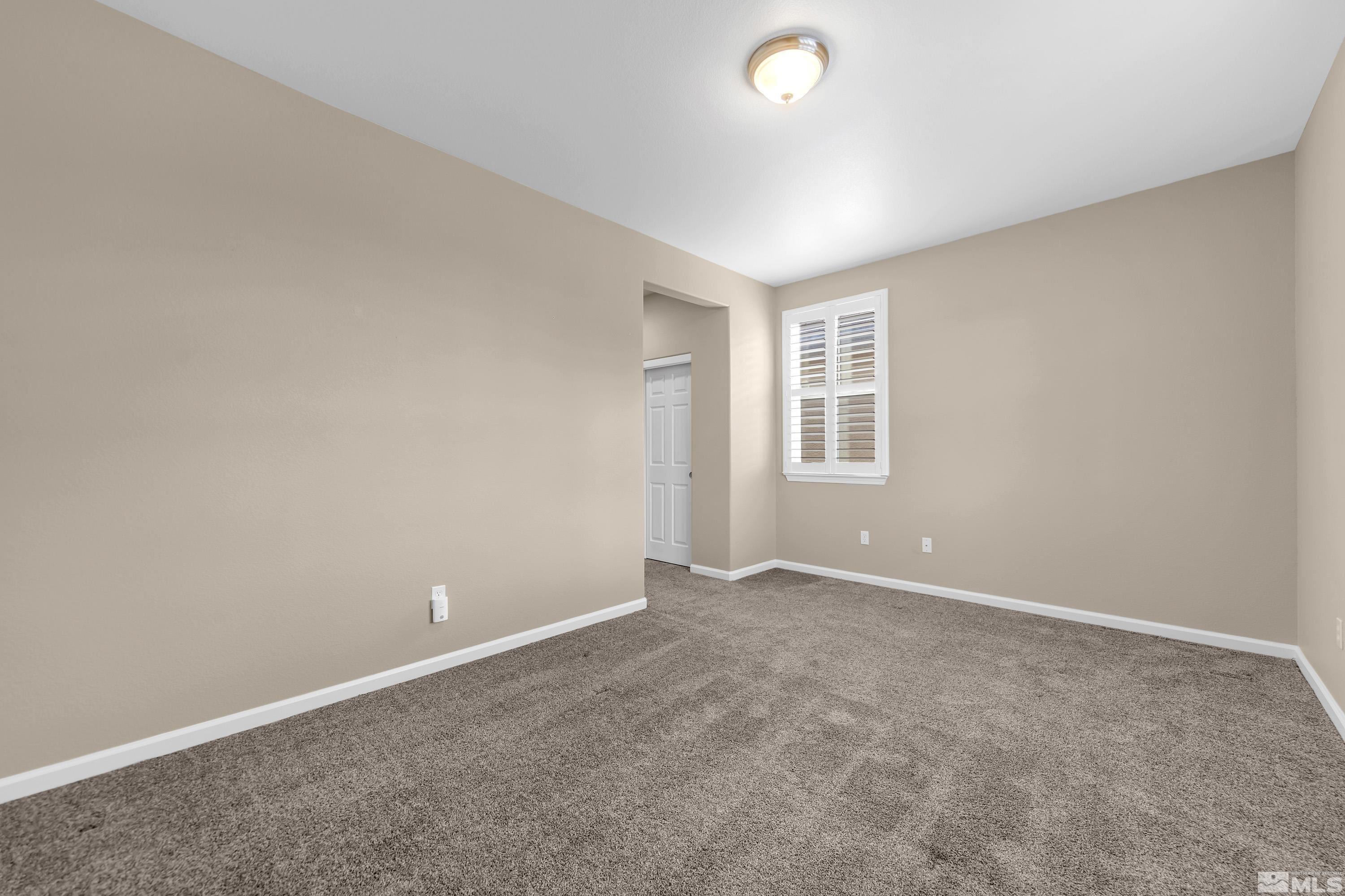 10797 Amber Falls Drive Reno, NV 89521 - Photo 20 of 38 an empty room with windows