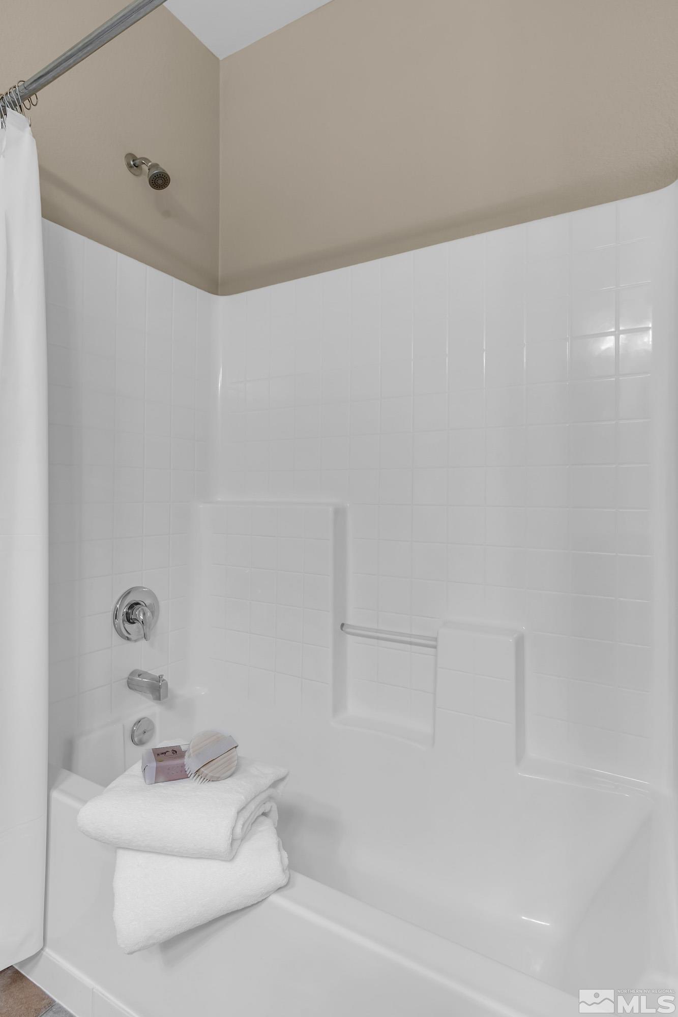 10797 Amber Falls Drive Reno, NV 89521 - Photo 24 of 38 a bathroom with a sink a mirror and shower