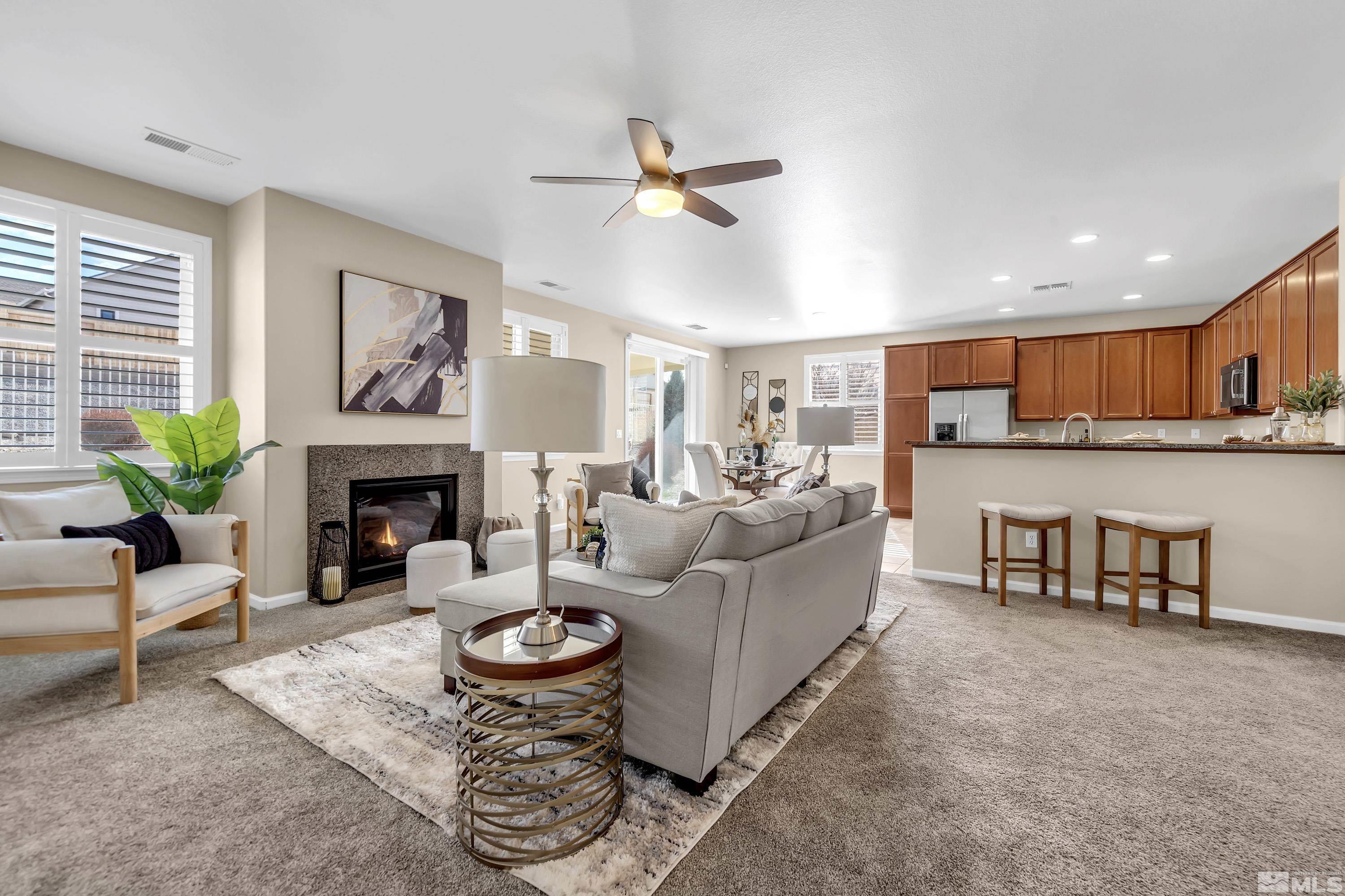 10797 Amber Falls Drive Reno, NV 89521 - Photo 9 of 38 a living room with furniture and a fireplace